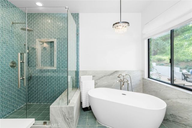 a view of a patio with couple of chairs and a fire pit