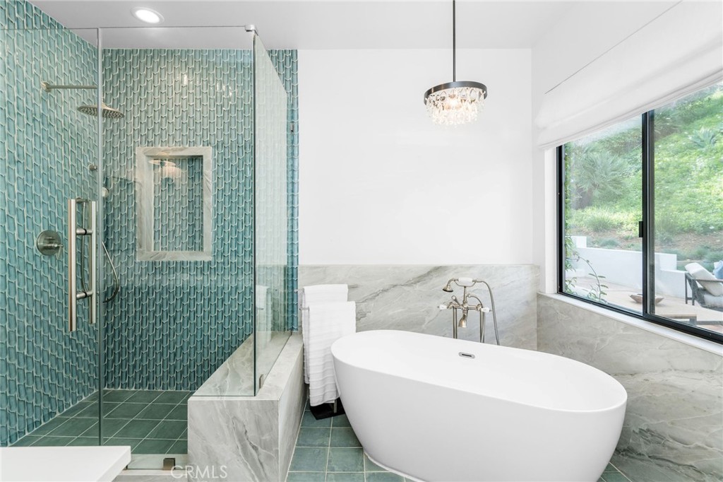 24743 Vantage Point Terrace Malibu, CA 90265 - Photo 47 of 64 a bathroom with a white bath tub sitting next to a window