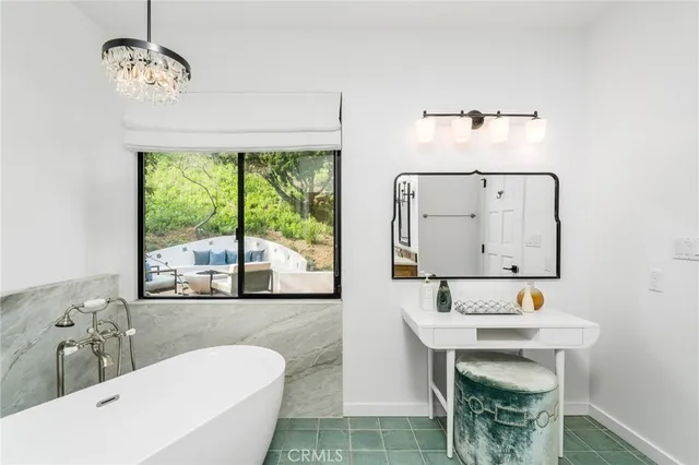 a view of a patio with couple of chairs and a fire pit
