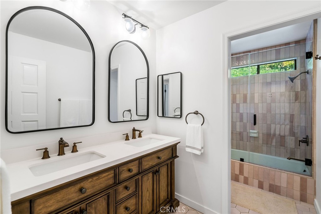 24743 Vantage Point Terrace Malibu, CA 90265 - Photo 55 of 64 a bathroom with a double vanity sink mirror and shower