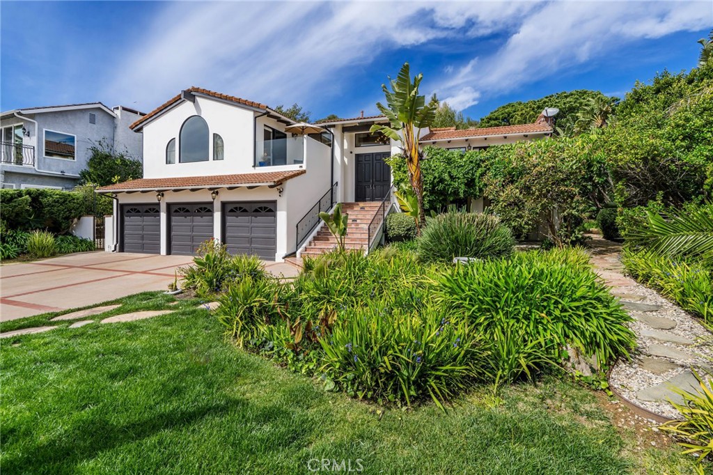 24743 Vantage Point Terrace Malibu, CA 90265 - Photo 6 of 64 a front view of a house with a yard