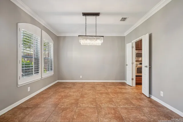 a view of a kitchen with kitchen island stainless steel appliances kitchen island granite countertop a refrigerator a oven and a sink with granite countertops