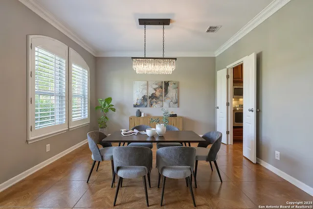 a living room with furniture kitchen view and a chandelier