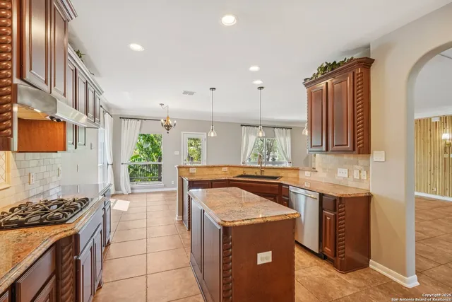 a bathroom with a granite countertop sink and a bathtub
