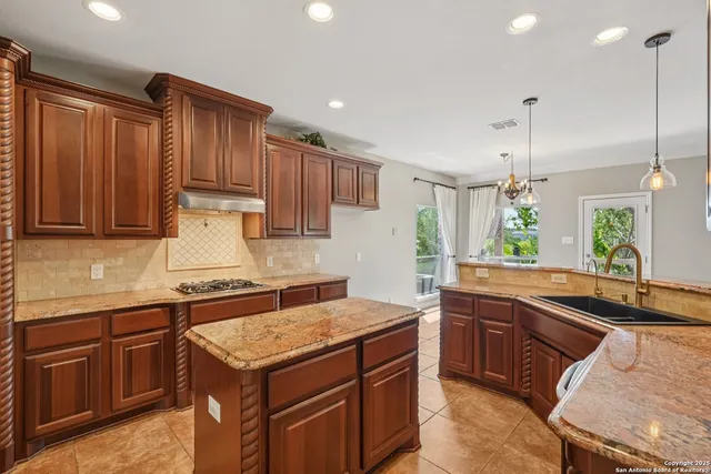 a spacious bathroom with a granite countertop sink a mirror and a