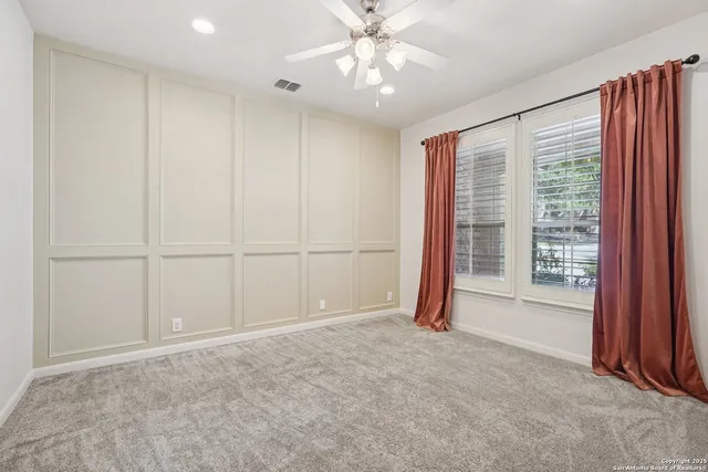 a spacious bathroom with a granite countertop sink a mirror and a bathtub