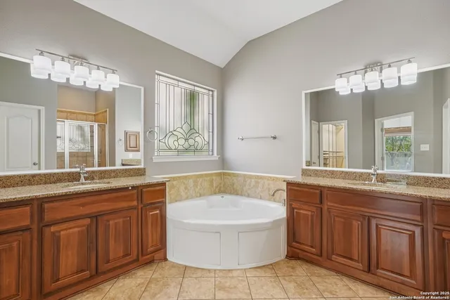 a view of a room with a ceiling fan and a window