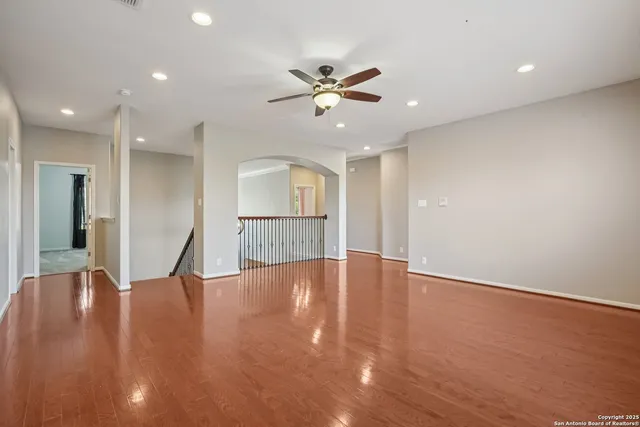 a view of a livingroom with a ceiling fan and window
