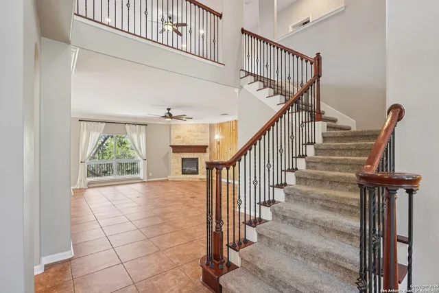 an empty room with windows and fireplace