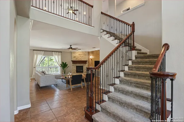 a living room with fireplace furniture and a large window