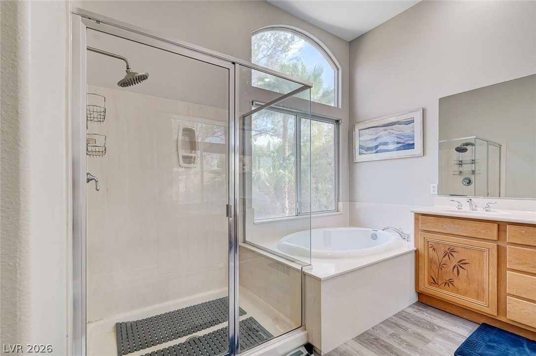 2391 Rainswept Avenue Henderson, NV 89052 - Photo 39 of 62 This bright bathroom features a spacious shower and a relaxing tub, creating a serene personal retreat.