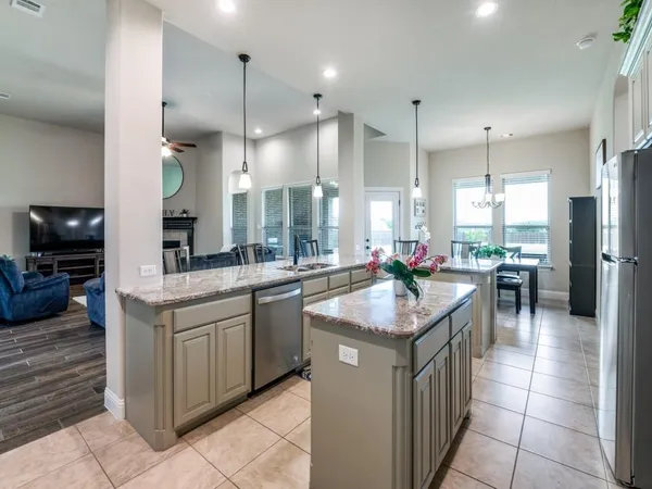 a kitchen with granite countertop counter top space a sink stainless steel appliances and cabinets