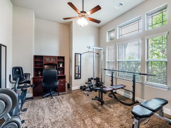 a room with gym equipment and a window