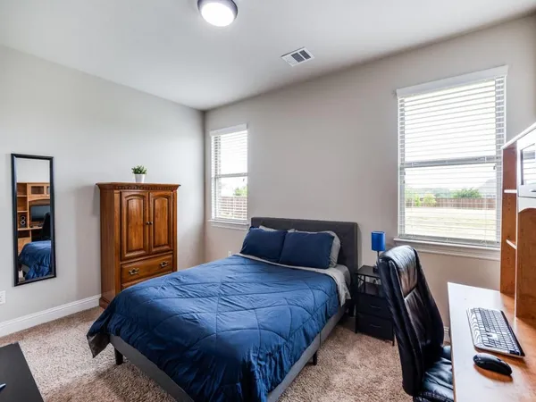 a bedroom with a large bed and a window