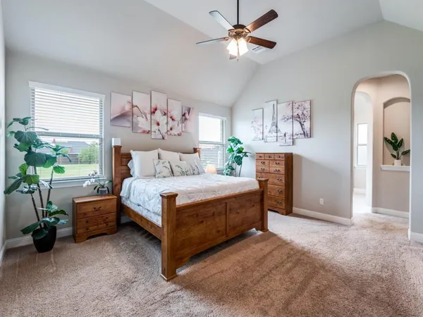 a bedroom with a bed and a chandelier