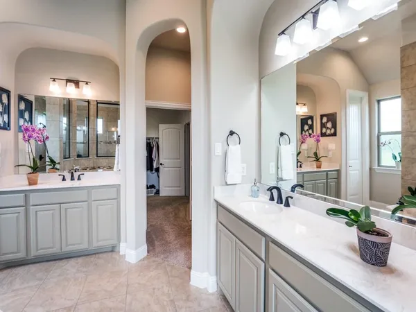 a bathroom with a double vanity sink and a mirror