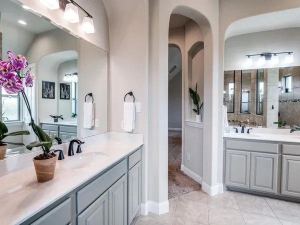 a bathroom with a double vanity sink and a mirror