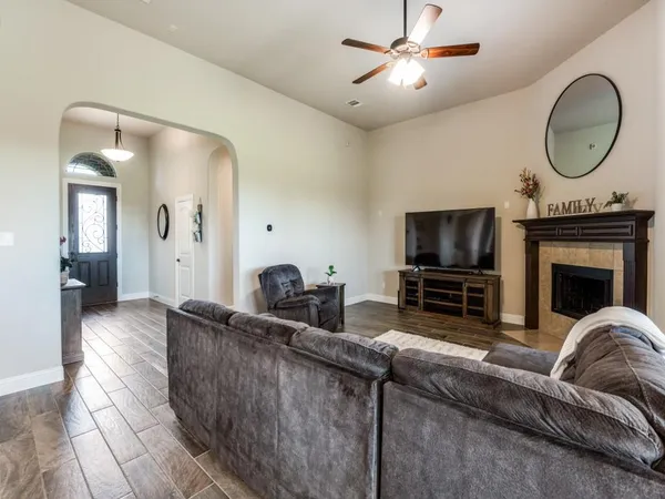 a living room with furniture a fireplace and a flat screen tv