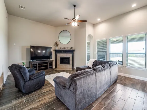 a living room with fireplace furniture and a flat screen tv