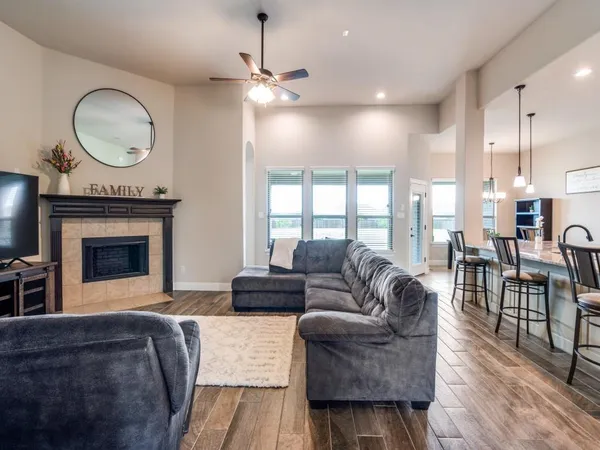 a living room with furniture a window and a fireplace