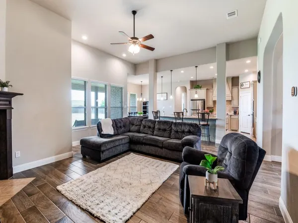 a living room with furniture and wooden floor