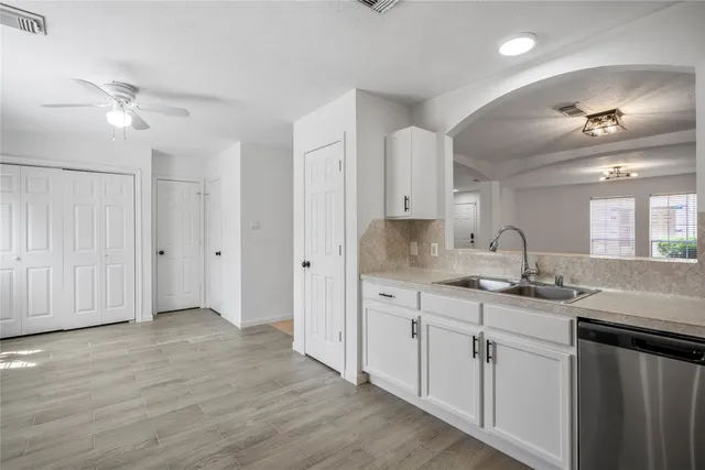 a kitchen with sink cabinets and wooden floor