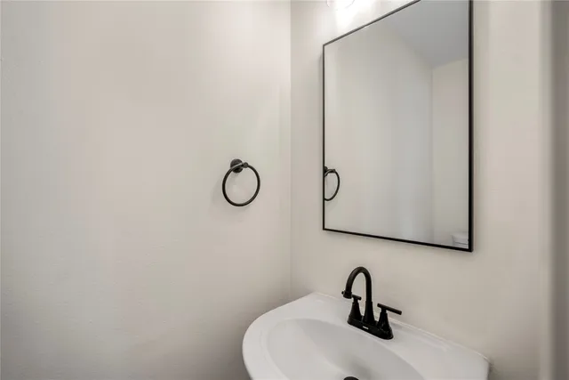 a bathroom with a sink and mirror