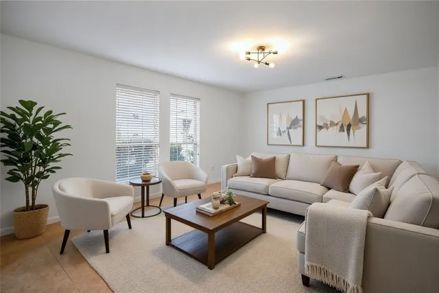 a living room with furniture and a large window