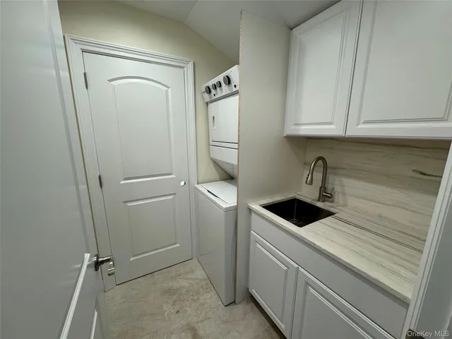a kitchen with white cabinets and white appliances