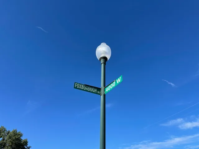 a view of a hallway with a wall and a potted plant