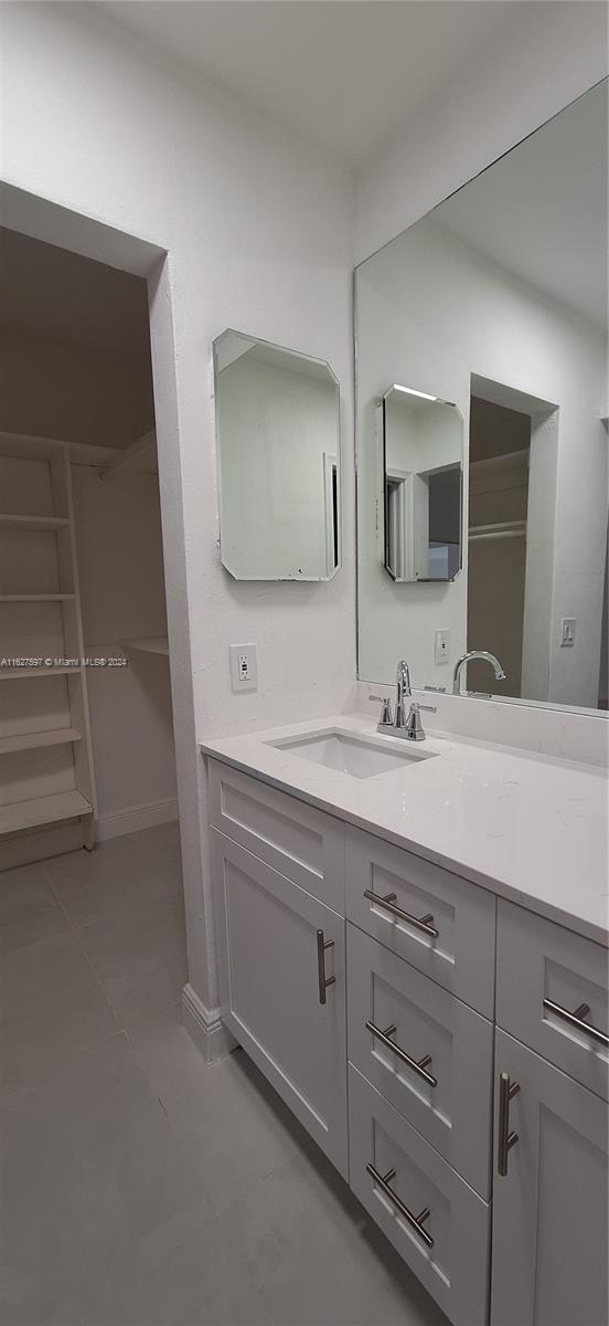 8620 Windsor Drive Miramar, FL 33025 - Photo 11 of 31 a bathroom with a double vanity sink and mirror