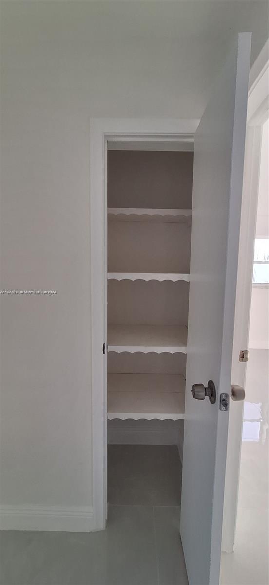 8620 Windsor Drive Miramar, FL 33025 - Photo 17 of 31 a view of walk in closet with empty racks