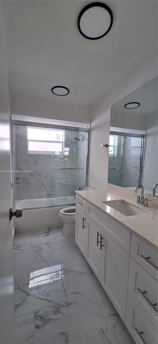 8620 Windsor Drive Miramar, FL 33025 - Photo 18 of 31 a bathroom with a granite countertop sink mirror and vanity