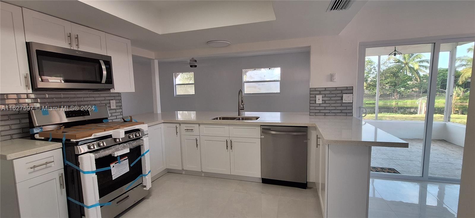 8620 Windsor Drive Miramar, FL 33025 - Photo 5 of 31 a kitchen with a stove and a microwave
