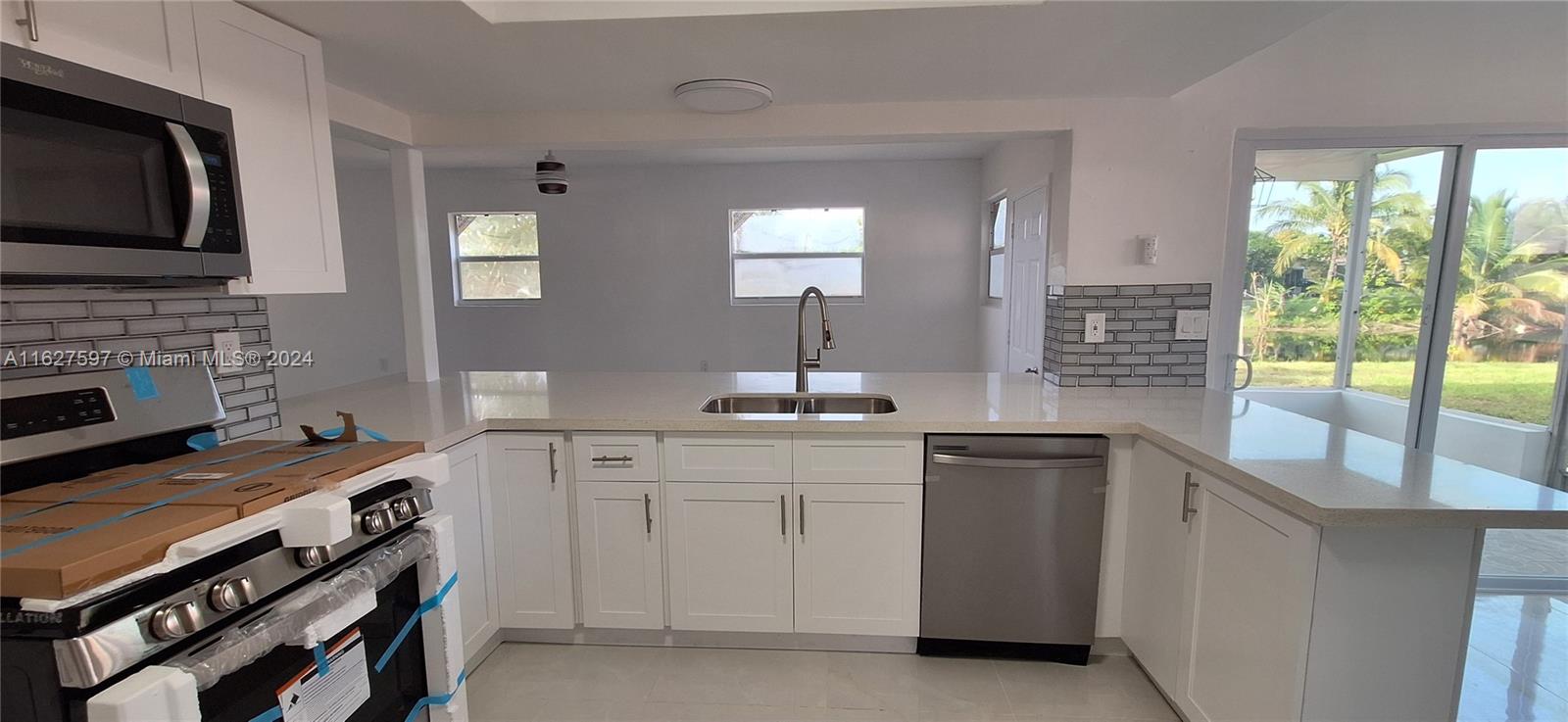 8620 Windsor Drive Miramar, FL 33025 - Photo 6 of 31 a kitchen with a sink stove and cabinets