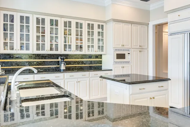 a kitchen with a sink a stove cabinets and counter space