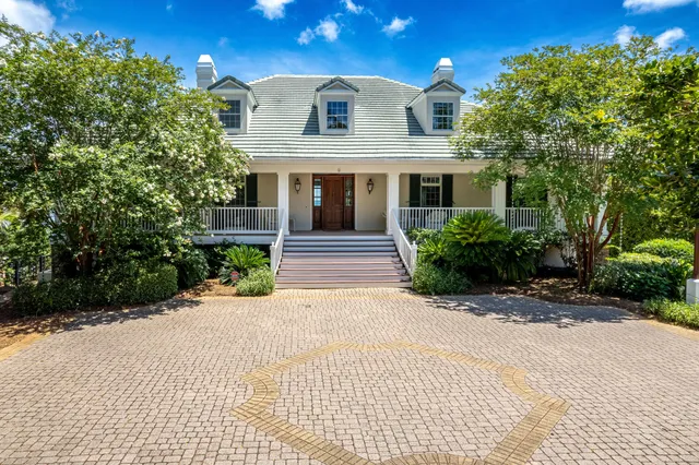 a living room with fireplace furniture and a large window
