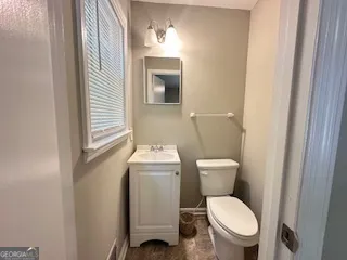 a white toilet sitting next to a bathroom sink