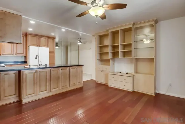 a view of kitchen with wooden floor and a window