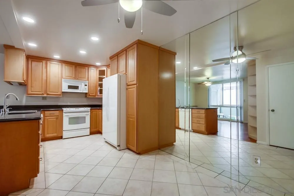 3333 Ruffin Road, Unit 4S San Diego, CA 92123 - Photo 12 of 34 a kitchen with stainless steel appliances granite countertop a refrigerator and a stove top oven