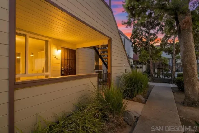 a view of a house with swimming pool and sitting area