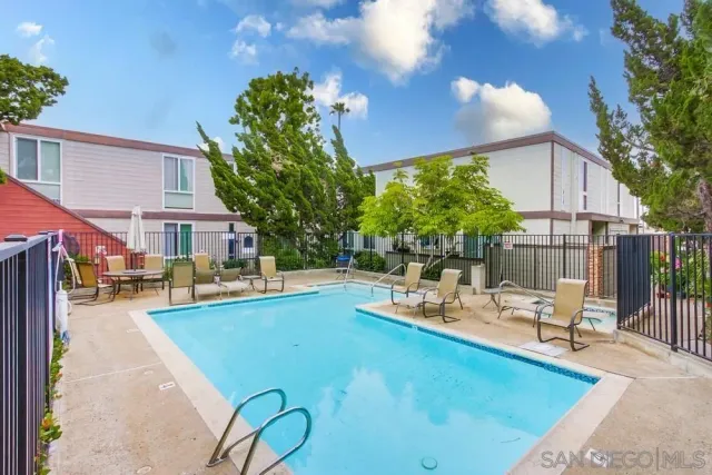 a view of a backyard with couches chair and table