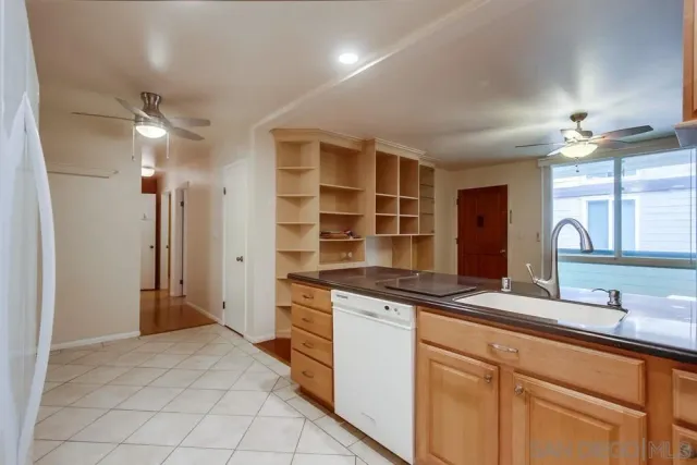 a kitchen with stainless steel appliances granite countertop a sink and a refrigerator