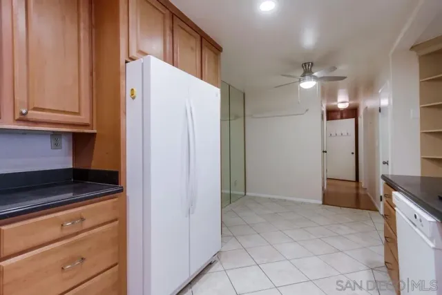 a kitchen with a refrigerator and cabinets