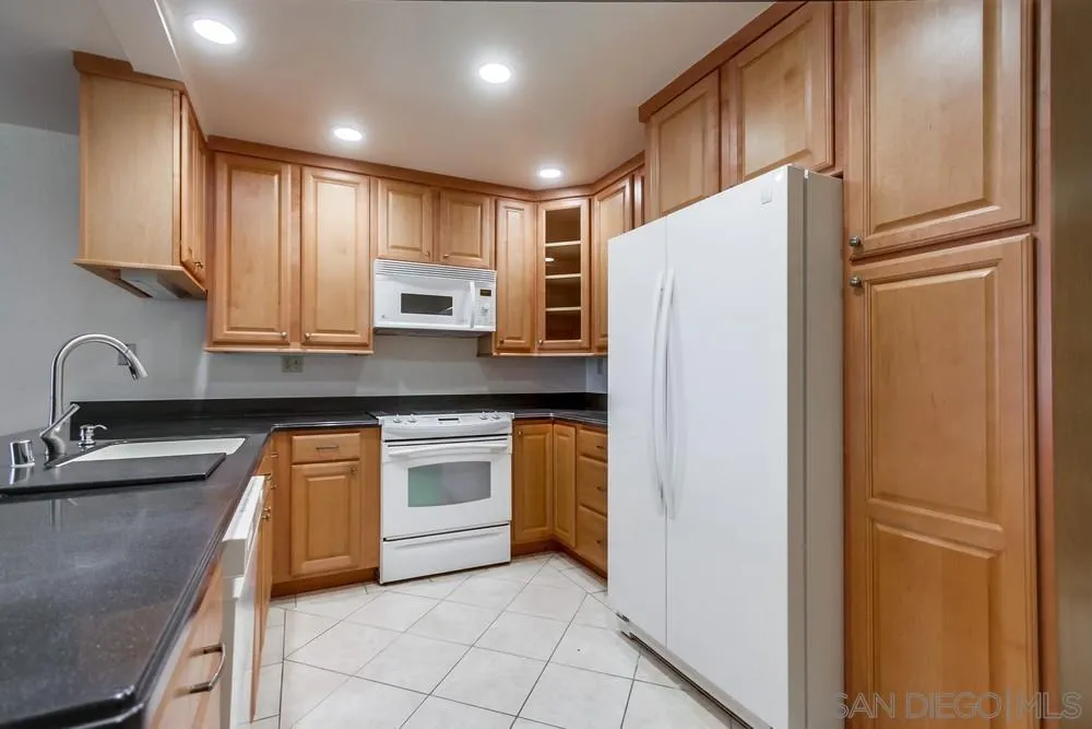 3333 Ruffin Road, Unit 4S San Diego, CA 92123 - Photo 10 of 34 a kitchen with stainless steel appliances granite countertop a refrigerator sink and stove