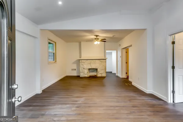 a view of an empty room and fire place