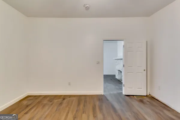 a view of an empty room and wooden floor