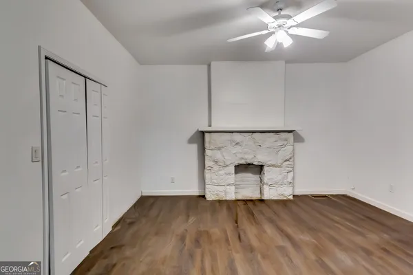 wooden floor in an empty room with a mirror