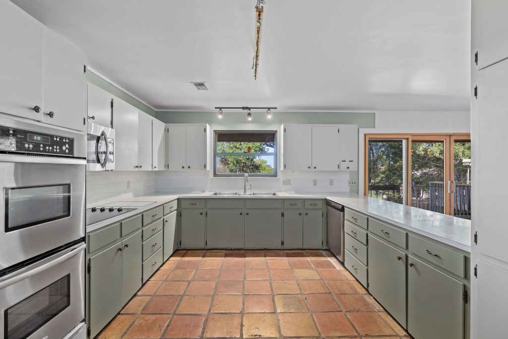 a large kitchen with a stove top oven