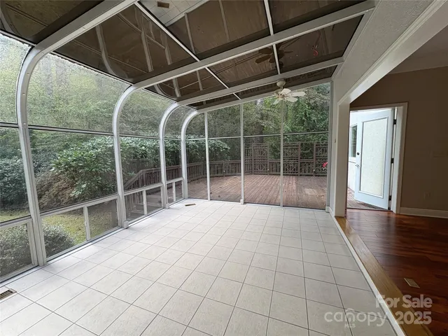 a view of empty room with wooden floor and windows